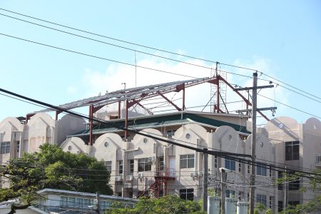 A new roof being constructed above the “sieve” that is the present roof of the Guyana Revenue Authority’s Camp Street Headquarters.