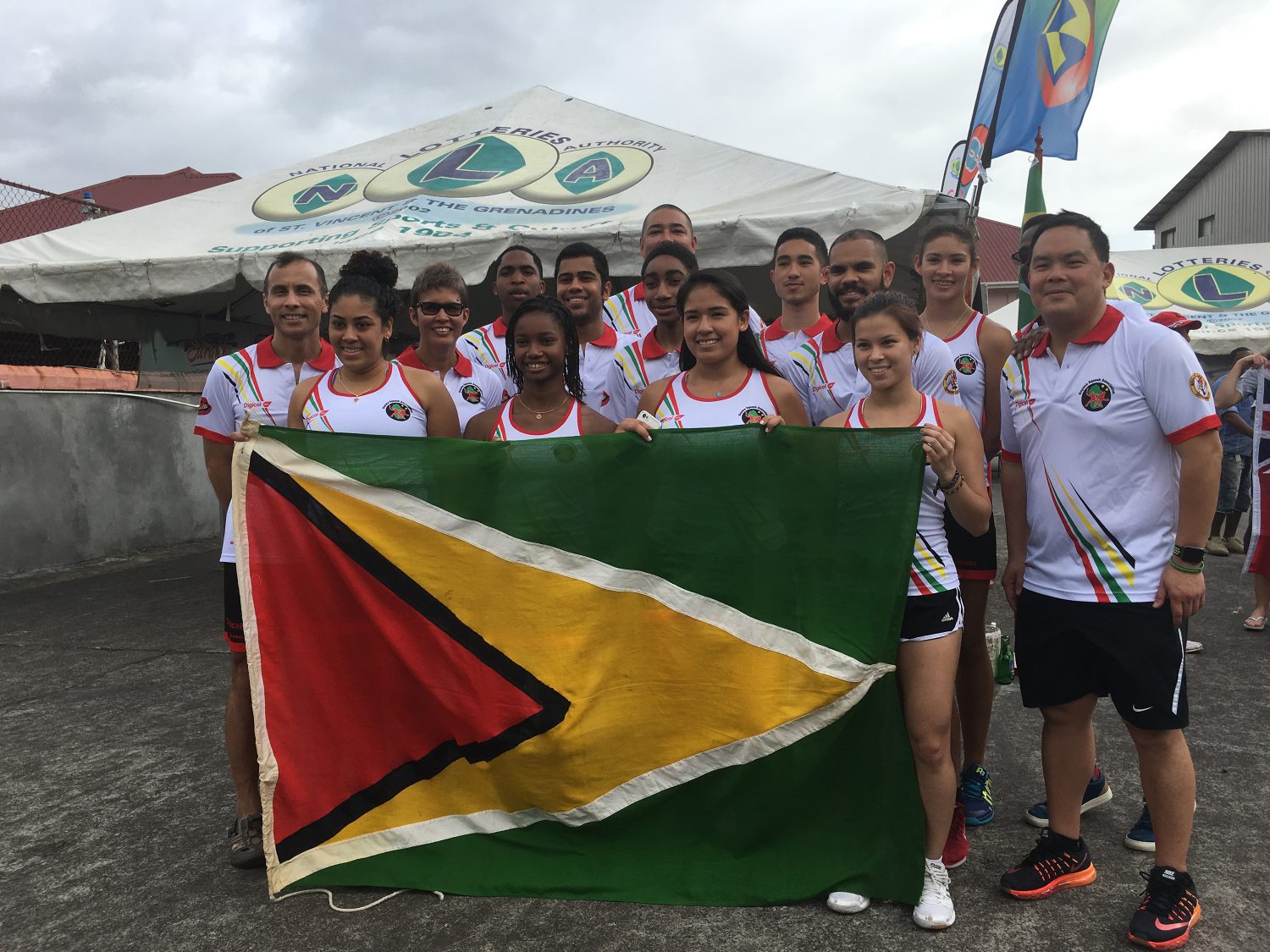 Guyana’s squash team at the XXV Senior Caribbean Squash Championships in St. Vincent and the Grenadines. Front row with the Guyana flag (left to right) Ashley Khalil, Larissa Wiltshire, Victoria Arjoon, Mary Fung-A-Fat, Second row (left to right) Richard Chin, Juanita Fernandes, Jason Ray Khalil, Shomari Wiltshire, Sunil Seth, Ramon Chan-A-Sue, Manager/Coach, Third row (left to right) Nyron Joseph, David Fernandes, Jean Claude Jeffrey, Taylor Fernandes, Alwyn Callender (partly hidden)





