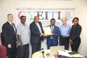 Minister of Natural Resources Raphael Trotman (third from left) submits Guyana’s application for membership to the Extractive Industries Transparency Initiative (EITI). Receiving the application on behalf of the EITI is the National Coordinator of the G-EITI, Rudy Jadoopat. Also in photo (from left) are ExxonMobil Country Manager Rod Henson, former Head of the Guyana Gold and Diamond Miners Association, Patrick Harding, G-EITI Civil Society representative Mike McCormack and Deputy Coordinator of the G-EITI Diane Barker. (Keno George photo)