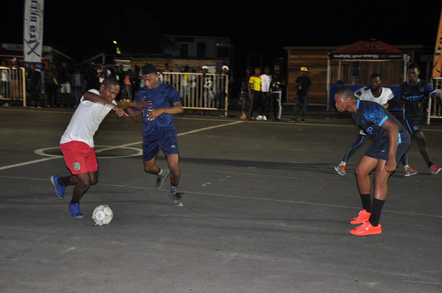 Jermaine Junior (left) of Tucville attempting to dribble a Silver Bullets player during the opening fixture of the group stage in the 3rd Annual Xtra Beer ‘Ballers in the Summer’ Street Football Championship at the Pouderoyen Tarmac