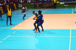 Tiger Bay’s Jason Fredericks (black) attempting to win possession of the ball from a Silver Bullets player during their elimination matchup at the National Gymnasium in the inaugural Guinness ‘Cage’ Football Championship.