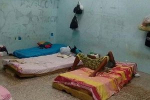 SQUALID: A detainee at the Immigration Detention Centre, Aripo, in a holding area with several mattresses across the floor.
