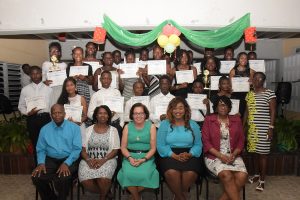 First Lady Sandra Granger (seated at centre) with the graduates and others. (Ministry of the Presidency photo)
