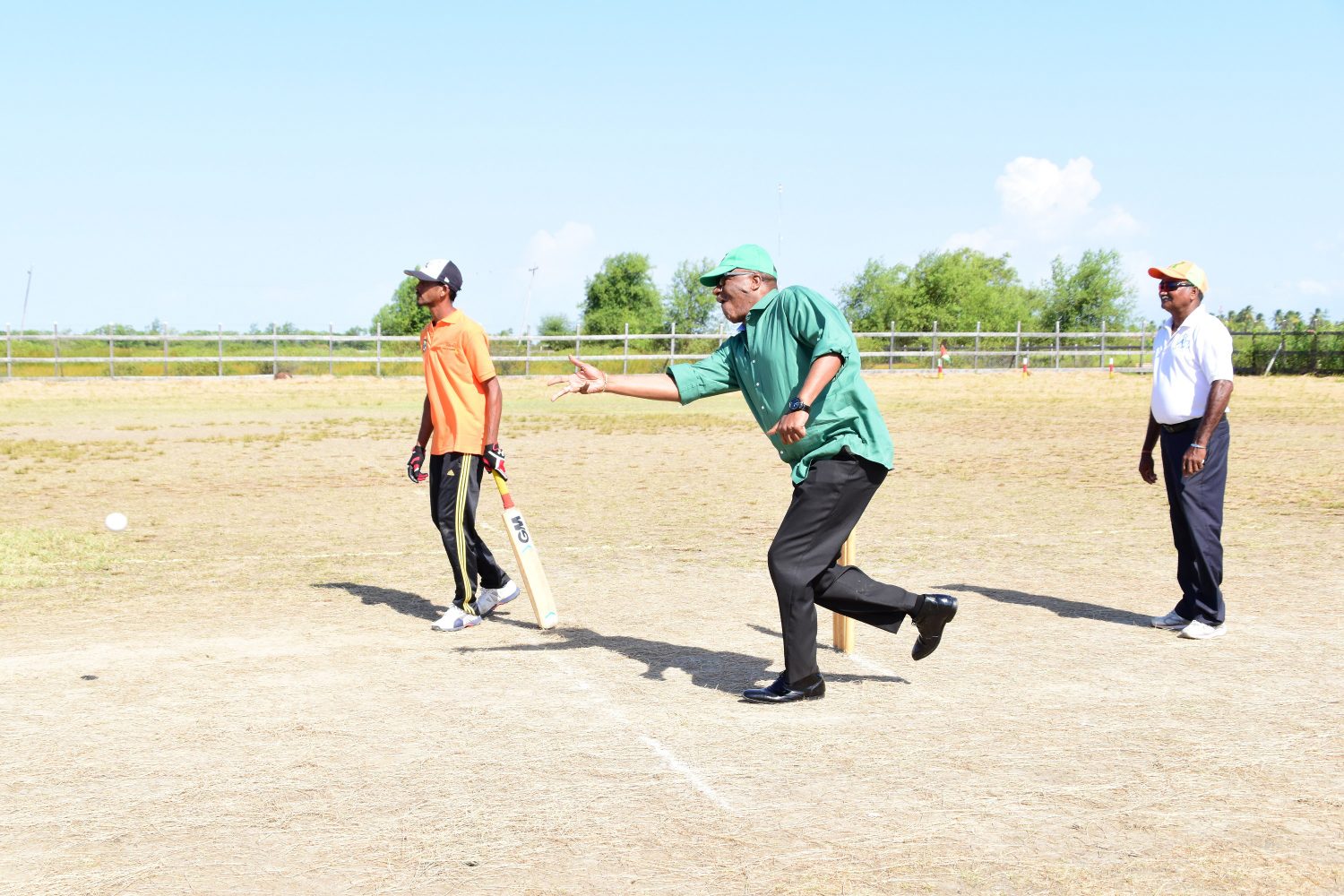 Minister of State, Joseph Harmon took to the field to bowl the first ball to kick start the finals of the cricket tournament. (Ministry of the Presidency photo)