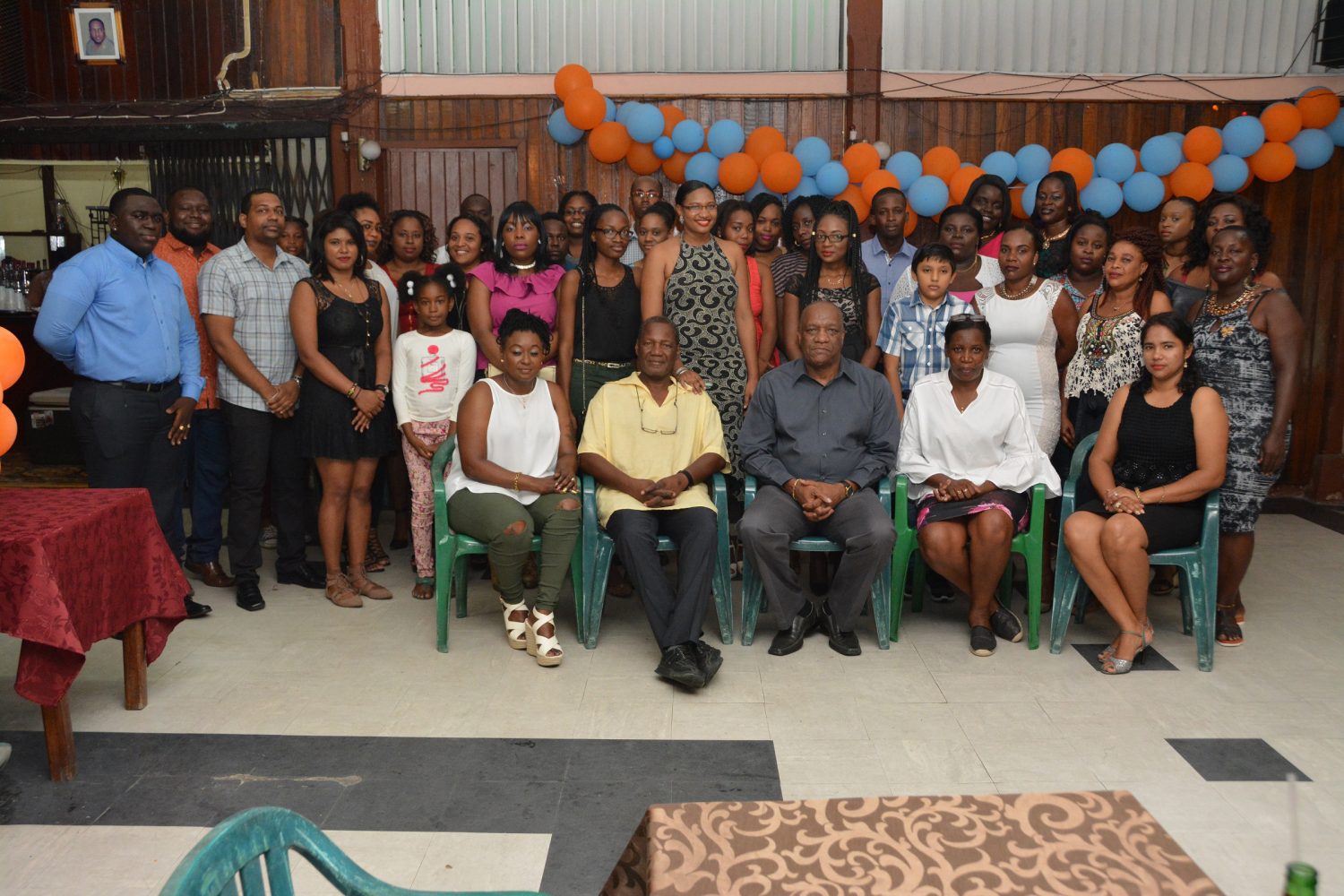 Minister of State, Joseph Harmon (seated centre) with the attendees at the event. (Ministry of the Presidency photo)