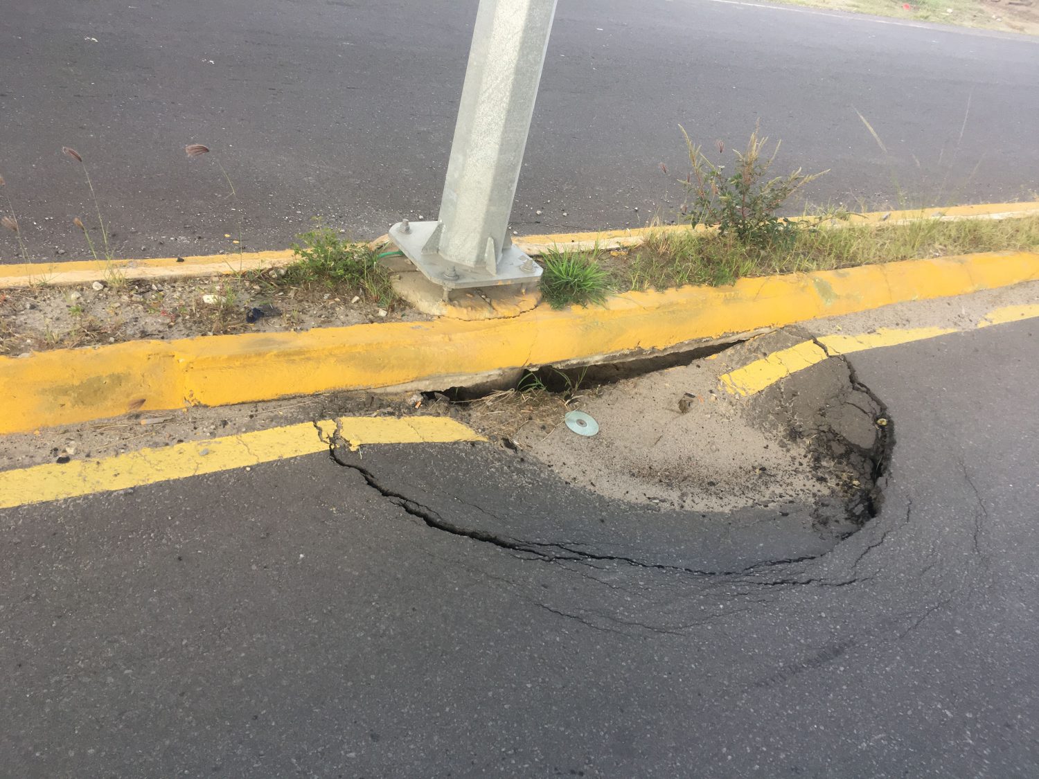 One of the holes which currently obstructs the flow of traffic on Carifesta Avenue 