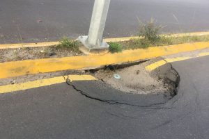 One of the holes which currently obstructs the flow of traffic on Carifesta Avenue 
