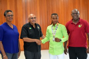 GOA’s President, K Juman-Yassin shakes the hand of Commonwealth Youth Championships silver medalist, Keevin Alllicock as the association’s Vice President, Dr. Karen Pilgrim and President of the GBA, Steve Ninvalle look on.