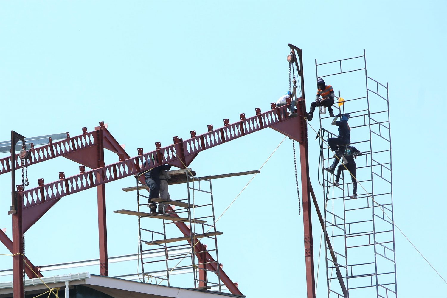 Not safe: While the Guyana Revenue Authority works to make their Camp Street Headquarters safer for their staff, the labourers are functioning in unsafe conditions. In this Keno George photo, workers at the site balance several hundred feet in the air without safety harnesses or any other visible form of safety gear.