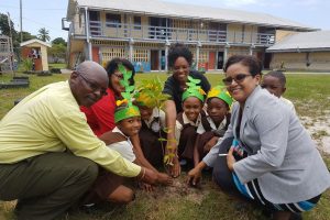 Ministry officials participating in the tree planting exercise at South Ruimveldt Park, Primary School  (DPI photo)
