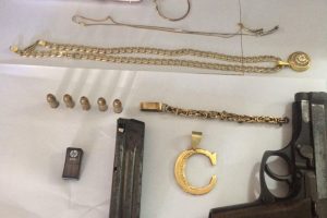 The jewellery, cellular phone and the unlicensed firearm and ammunition that were found in the car. (Guyana Police Force photo)