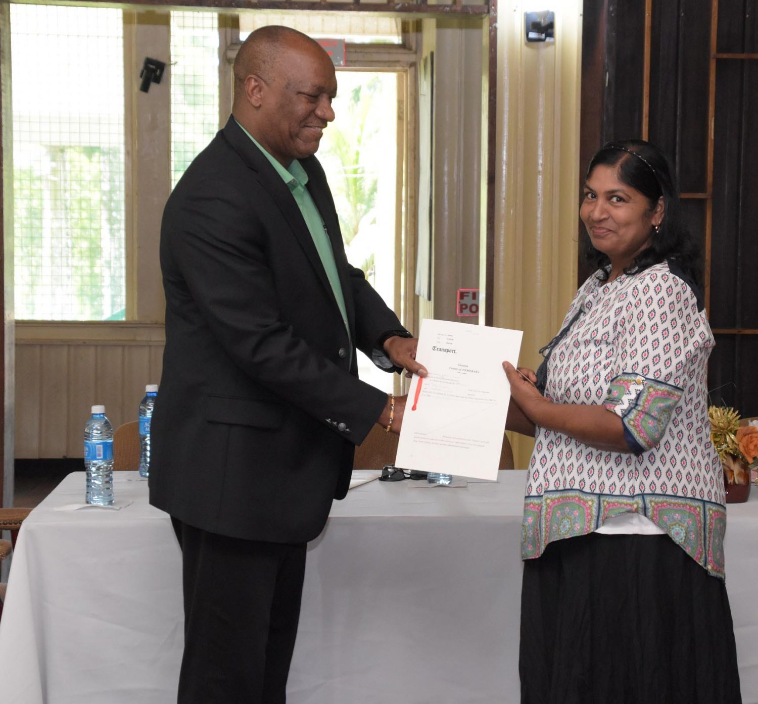Bibi Ameena a receiving her title from Minister of State, Joseph Harmon (Ministry of the Presidency photo)




