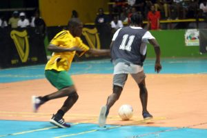 Omallo Williams (right) of Leopold Street attempting to evade the challenge of Mocha’s Amos Ramsay during their clash in the quarterfinal round of the Guinness ‘Cage’ Football Championship
