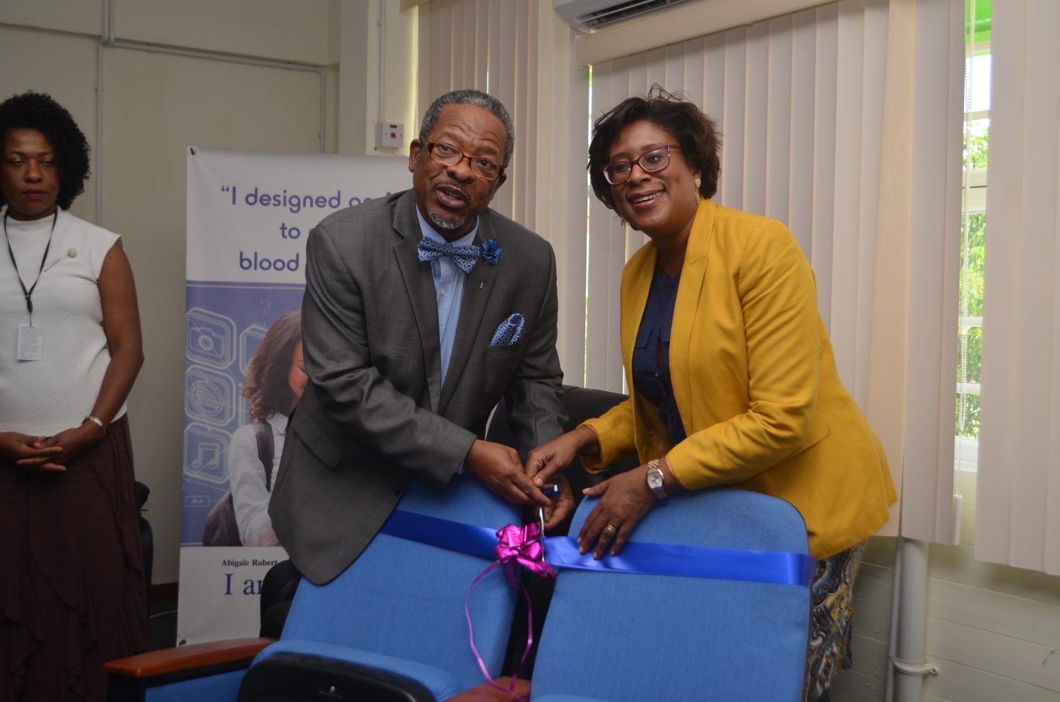 Catherine Hughes, Minister of Public Telecommunications, hands over the chairs to Dr. Ivelaw Griffith, Vice Chancellor and Principal of The University of Guyana (DPI photo)
