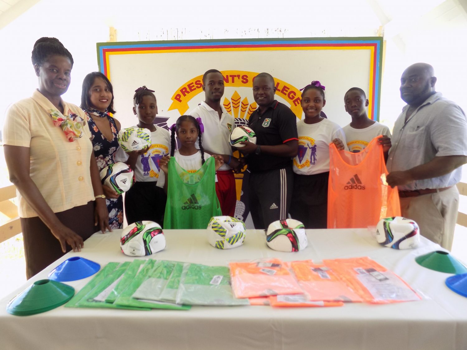 President’s College Physical Education Teacher Willon Cameron collects the donation in the presence of students and staff of the school from GFF’S Youth Development Officer (YDO) Bryan Joseph (fourth from right).