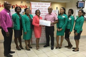 Products and Marketing Manager for Scotiabank Jennifer Cipriani hands over a symbolic cheque to Club Captain Brian Glasford