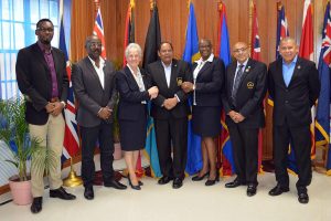 Acting President, Moses Nagamootoo (standing centre) who delivered the keynote address at the Commonwealth Games Federation (CGF) meeting of the Americas and the Caribbean poses for a photo with several key Commonwealth Federation figures following the meeting yesterday at Olympic House. From Left, Christopher Jones, Chet Greene, Louise Martina, Fortuna Belrose, K. A Juman Yassin and Dr. George Norton. (Orlando Charles photo)
