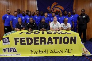 CONCACAF Instructors Juan Carlos Michia ( left) and Lenny Lake (2nd left), GFF President Wayne Forde (centre), GFF Technical Director Ian Greenwood (2nd right), Executive Committee member Keith O’Jeer (right) and the participating coaches (standing) following the launch of the CONCACAF D-Licence Programme  
 
