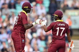 Captain Jason Holder (left) and Evin Lewis meet during their 168-run, fifth wicket stand in yesterday’s fourth ODI. (Photo courtesy CWI Media)
