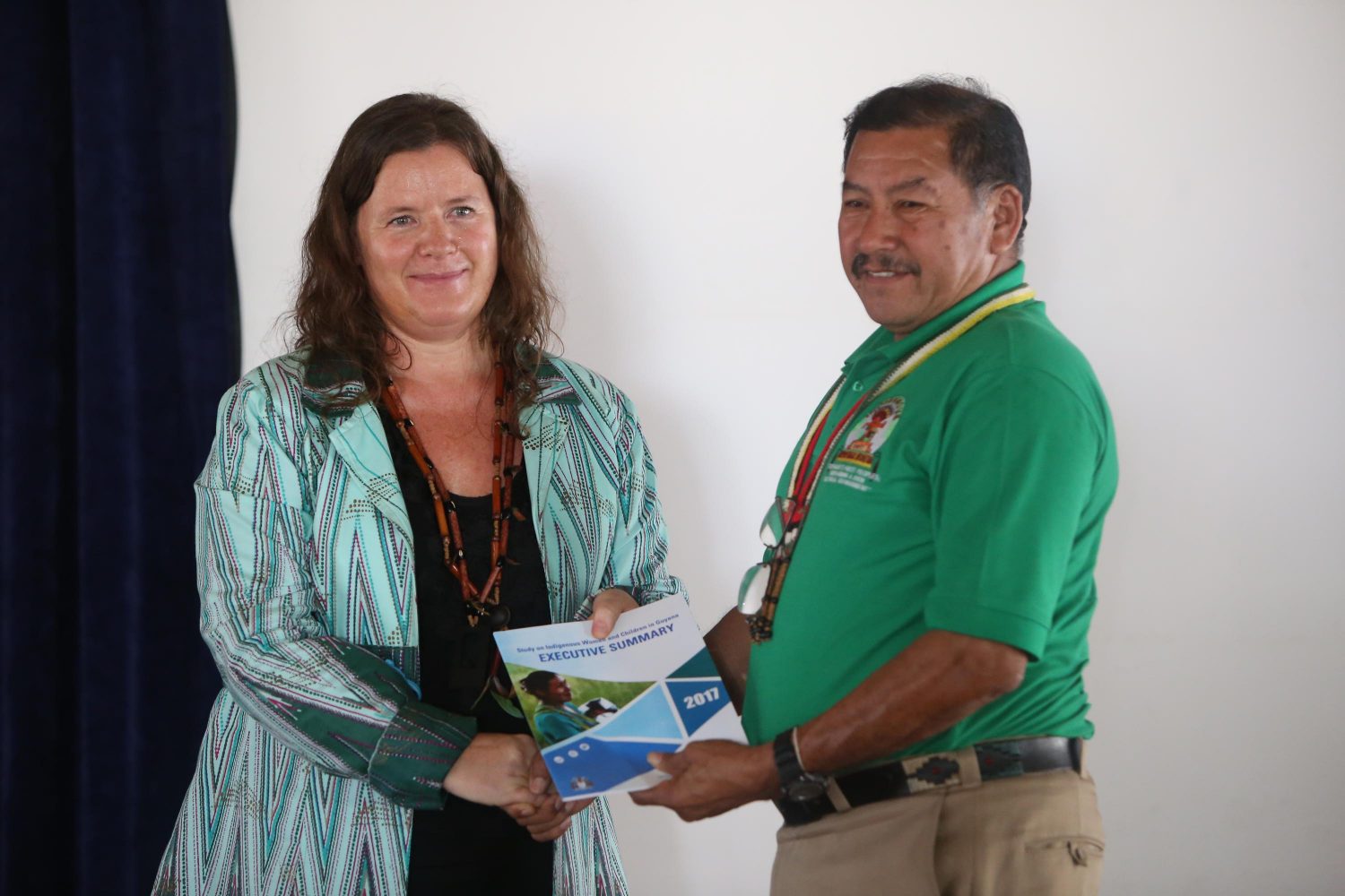 UNICEF Permanent Representative to Guyana and Suriname Sylvie Fouet handing over the Executive Summary of the study on Indigenous Women and Children in Guyana to Minister of Indigenous Peoples’ Affairs Sydney Allicock on Friday. (Keno George photo)  
