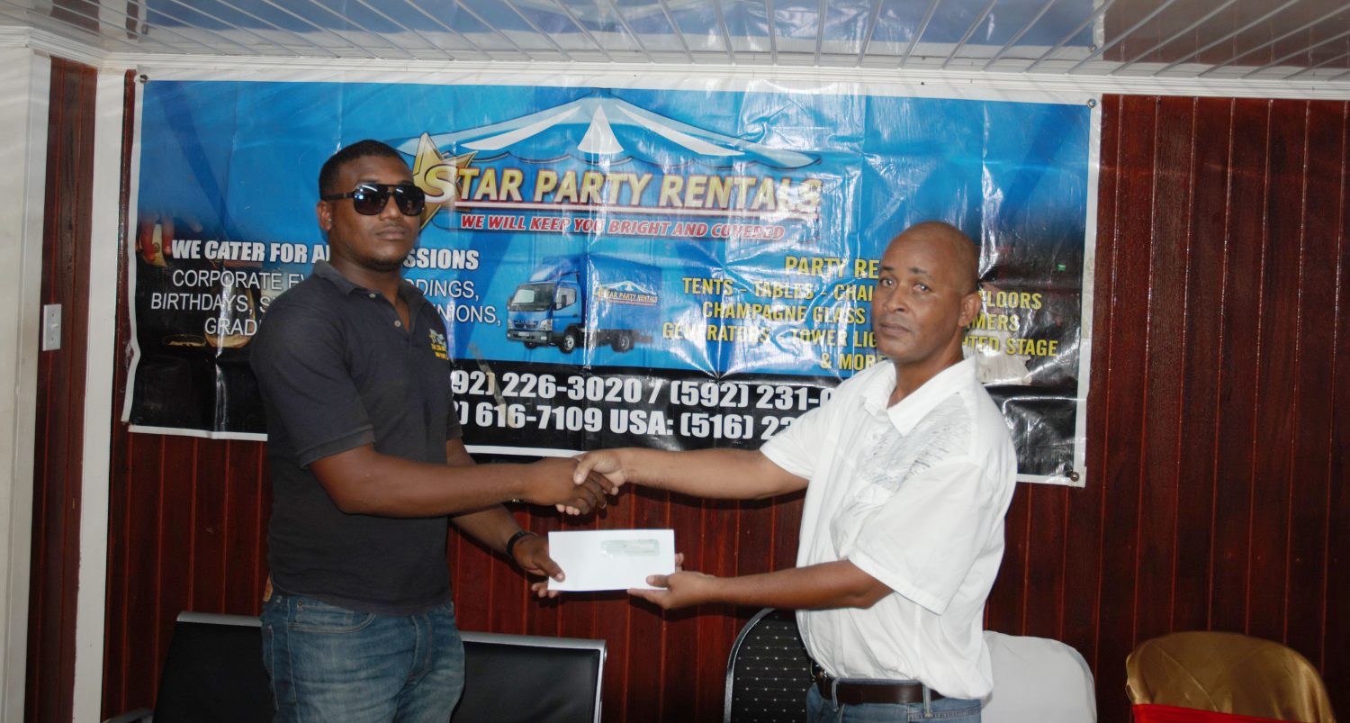 Rawle Welch (right) of event coordinator Three Peat Promotions, collects the sponsorship cheque from Star Party Rentals representative Colwyn Vyphius.