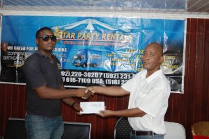 Rawle Welch (right) of event coordinator Three Peat Promotions, collects the sponsorship cheque from Star Party Rentals representative Colwyn Vyphius.