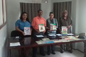 (From left): Members of The Guyana Annual 2018 Committee of Management, Danielle Swain, Petamber Persaud, Shamshun Mohamed and Allan Fenty, hold up past editions of the magazine.