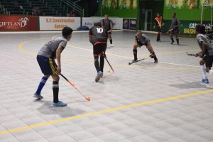 Jamarj Assanah (No.10) of National Blacks on the attack against St Stanislaus during their men’s  first division fixture in the GTT National Indoor Football Championship at the Cliff Anderson Sports Hall Tuesday night.
