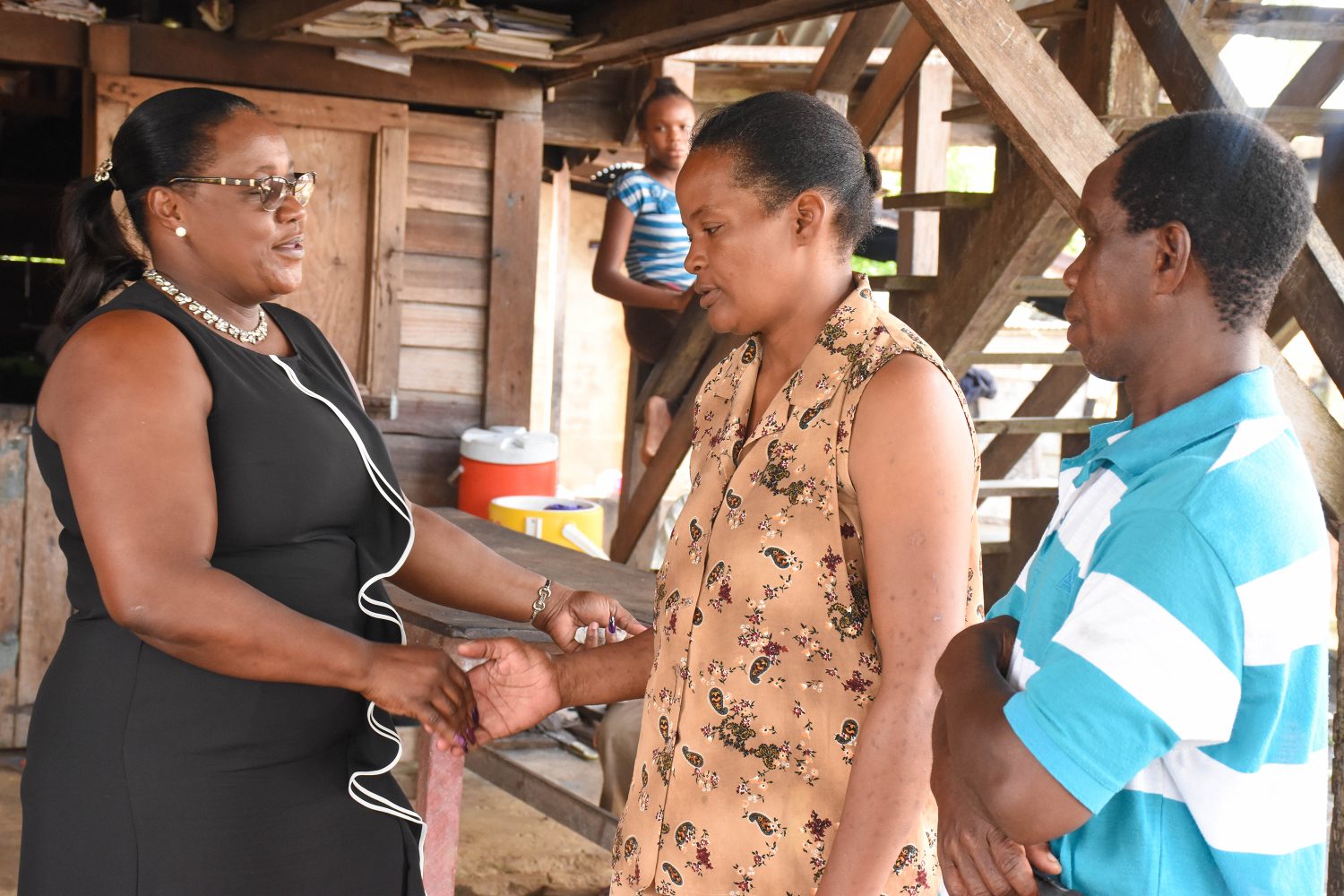 Minister within the Ministry of Natural Resources Simona Broomes (left) meeting the parents of the late Leonard Archibald (DPI photo)