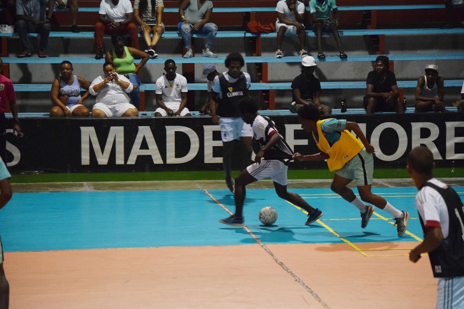 Omallo Williams (centre) of Leopold Street racing away from Keiron Solomon of Future Stars in the Guinness ‘Cage’ Football Championship semi-final matchup at the National Gymnasium, Mandela Avenue.  