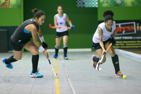 Latacia Chung (right) of the National Ladies team tries to avoid the challenge from SIDM’s Nicolette Fernandes during their clash in the GTT National Indoor Championship women’s division at the Cliff Anderson Sports Hall Monday night.
