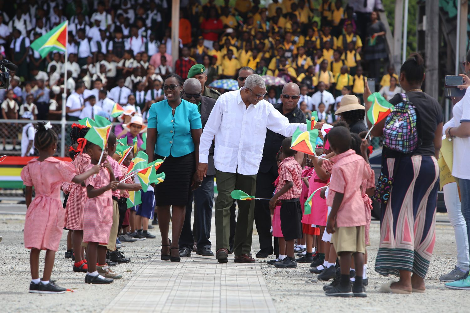Education Minister Nicolette Henry and President David Granger greet students at D’Urban Park, where the National Education Day rally and exhibition was held. (Photo by Keno George)