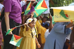In the spirit: A young student waves a flag during the National Education Day rally at D’Urban Park. See story and more photos on centre pages. (Photo by Keno George)