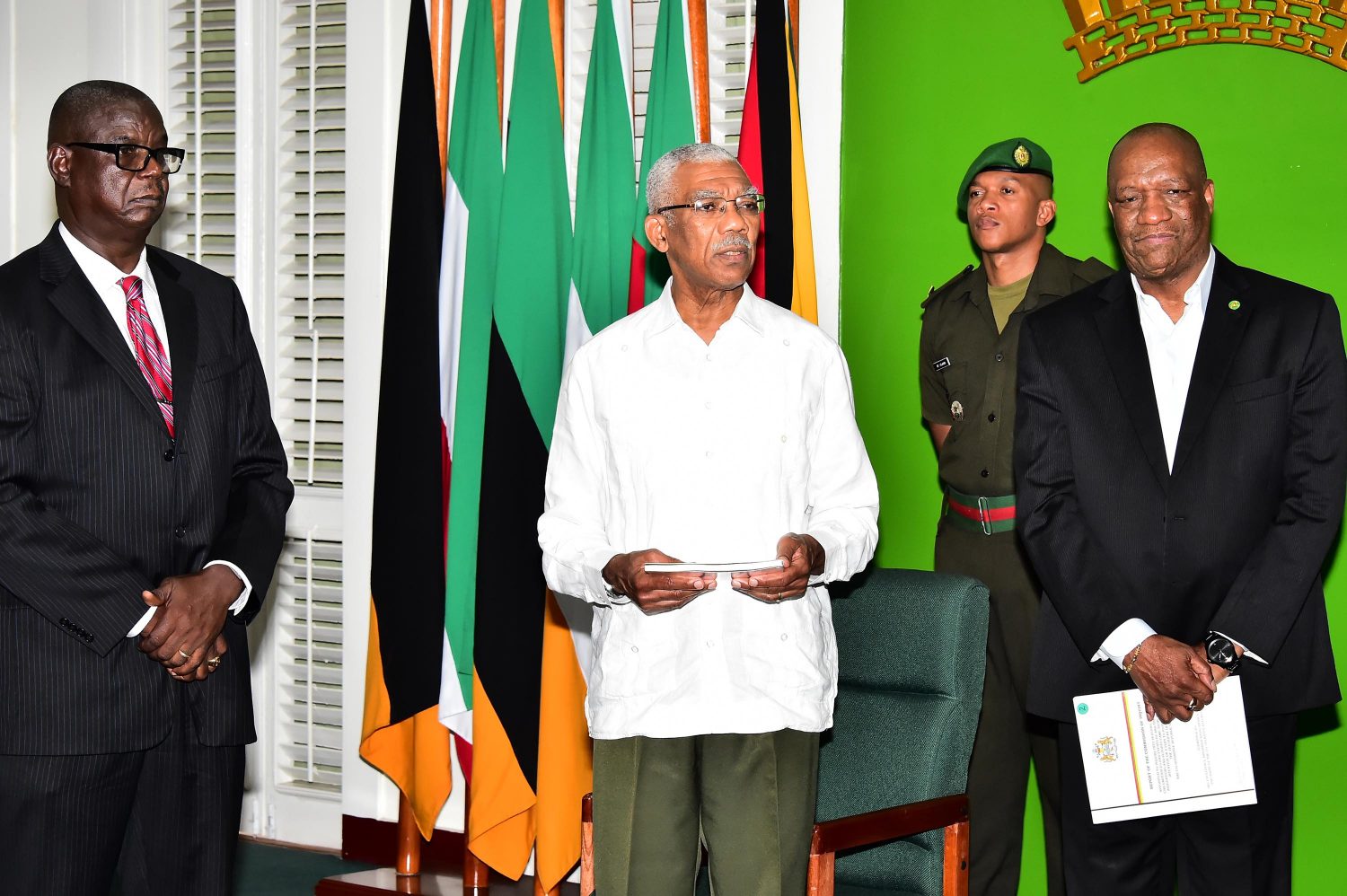 President David Granger (second from left) addressing members of the media after receiving the Report as Head of the Commission, Paul Slowe (left) and Minister of State, Joseph Harmon look on. (Ministry of the Presidency photo)