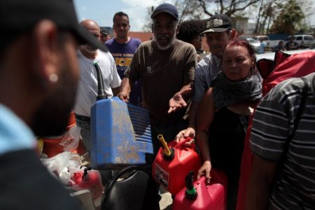 People queue at a gas station to fill up their fuel containers, after the island was hit by Hurricane Maria, in San Juan, Puerto Rico September 28, 2017. REUTERS/Alvin Baez
