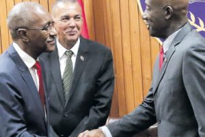 Welcome back…Prime Minister Dr Keith Rowley, right, congratulates Public Utilities Minister Robert Le Hunte after he was sworn in for a second time by President Anthony Carmona, centre, during a ceremony at the Office of the President in St Ann’s last evening.