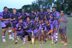 Back-to-back! The Panthers Rugby Club pose with their winning trophies yesterday. (Orlando Charles photo)