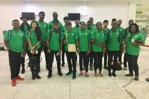 Guyana’s contingent of athletes and officials pose for a photo yesterday before departing the Cheddi Jagan International Airport for Santiago, Chile where they will compete in the second South American Youth Championships.