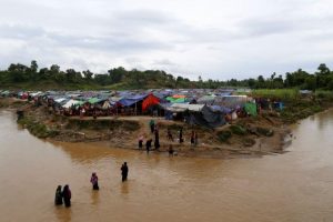 Rohingya refugees cross a stream to reach their temporary shelters at No Man’s Land between Bangladesh-Myanmar border, at Cox’s Bazar, Bangladesh, September 9, 2017. REUTERS/Danish Siddiqui