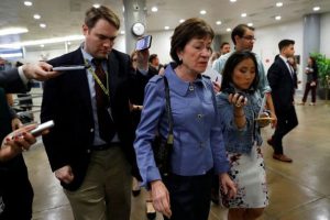 Susan Collins (centre) speaking to reporters yesterday (Reuters photo)