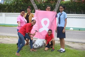 Family Affair: This family yesterday participated in the tree wrapping exercise organised along the Camp Street avenue in observance of Breast Cancer Awareness Month. The event was organised by the Guyana Cancer Foundation and GTT. (Photo by Keno George)
