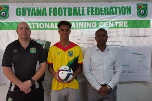 The latest overseas recruit, England-based Terrence Vancooten (centre) poses with GFF President Wayne Forde (right) and GFF Technical Director Ian Greenwood prior to joining the camp for Grenada International Friendly.