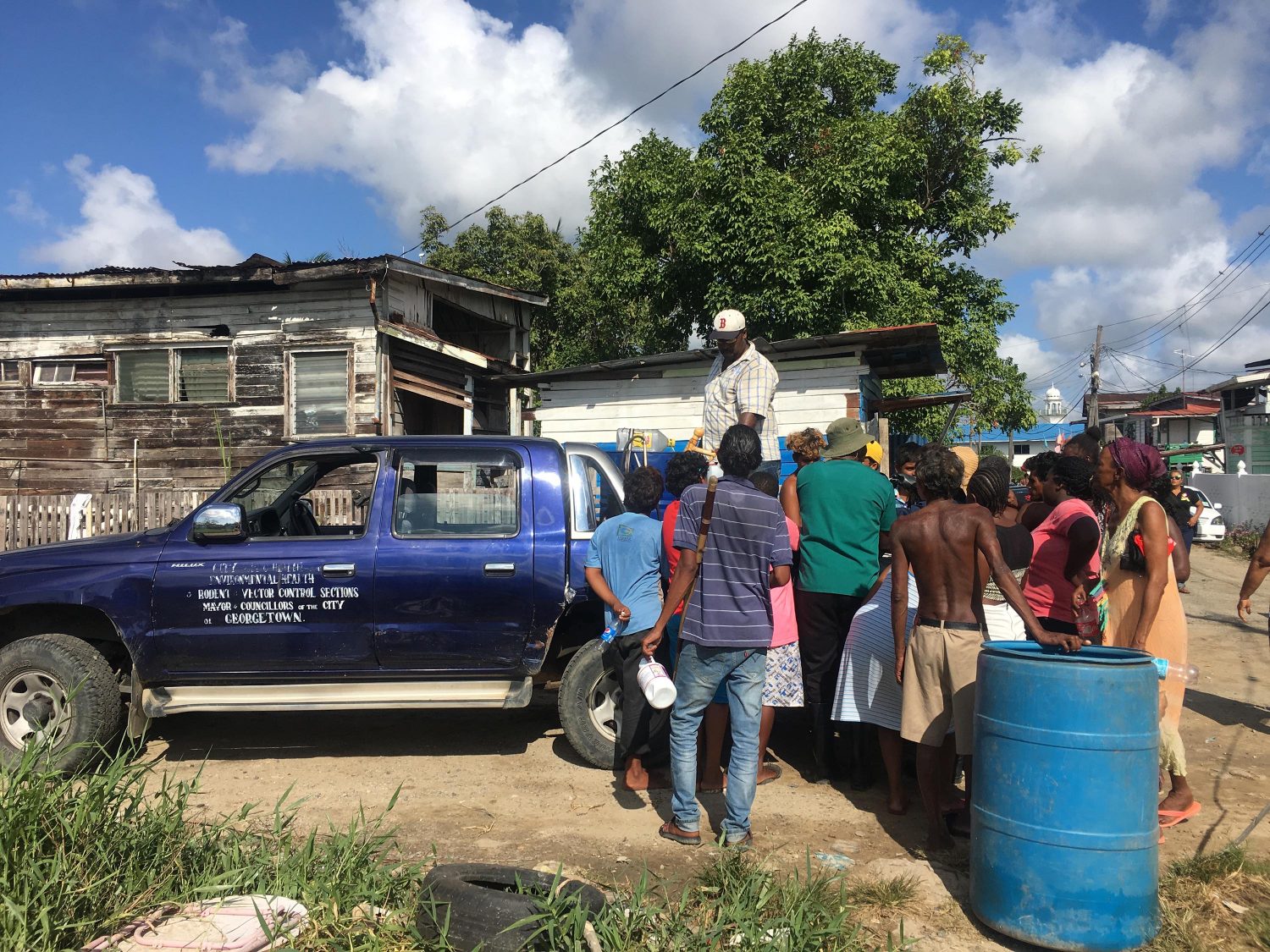 Residents of River View gathered around a Mayor and City Council vehicle to collect cleaning supplies yesterday. 
