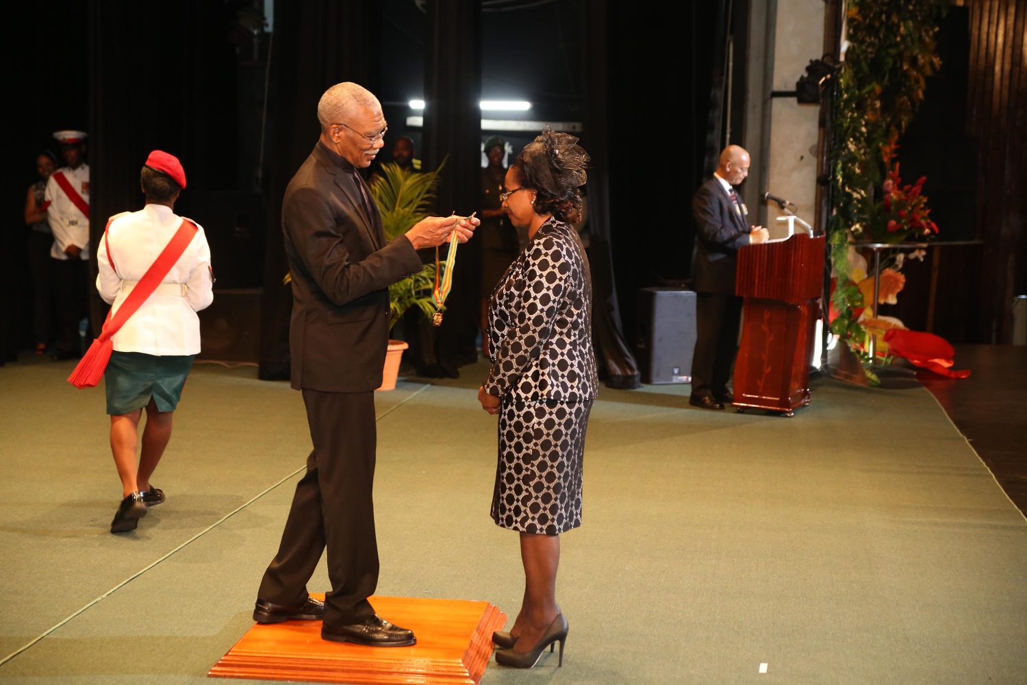 President David Granger about to confer the Order of Roraima on acting Chancellor Justice Yonnette Cummings-Edwards, who was the lone recipient of the award at this year’s Investiture under the Orders of Guyana, which was held yesterday at the National Cultural Centre. See story on centre pages. (Photo by Keno George)
