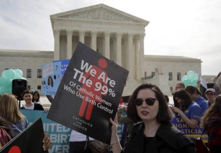 Supporters of contraception rally before Zubik v. Burwell, an appeal brought by Christian groups demanding full exemption from the requirement to provide insurance covering contraception under the Affordable Care Act, is heard by the U.S. Supreme Court in Washington, U.S., March 23, 2016. REUTERS/Joshua Roberts/File Photo
