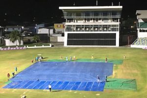 Ground-staff put the covers in place at Kensington Oval following the abandonment of play
