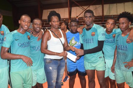 Captain of Future Stars Jeremy Garrett, collecting the winner’s cheque from a representative of Street Vibes Entertainment in the presence of his teammates, following the conclusion of the final at the National Gymnasium