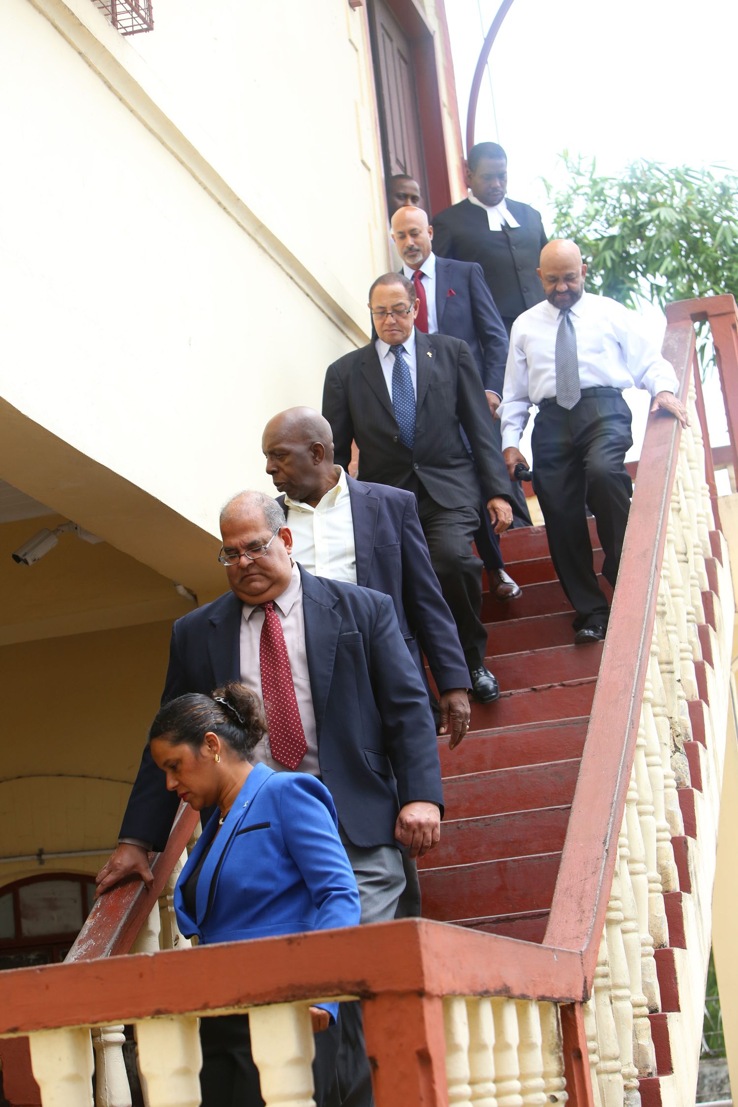 Six members of the GBTI board of directors making their way down the stairway from the courtroom of Chief Magistrate Ann McLennan 