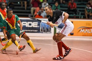 Roberts on the go-Canada’s six goalscorer Jonathan Roberts (centre) launching one of his many attacking forays against Guyana during their group clash in the Pan American Indoor Hockey Championship at the National Gymnasium last evening
