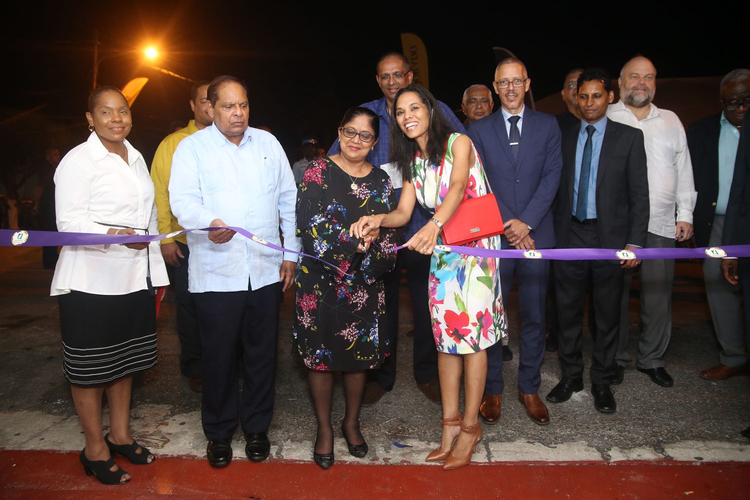 Han Gaskin (front right), wife of Minister of Business Dominic Gaskin (fourth from right) and Sita Nagamootoo, wife of Prime Minister Moses Nagamootoo (second from left) cut the ribbon last evening to mark the opening of Guyanese Flavour UNCAPPED. (Photo by Keno George)
